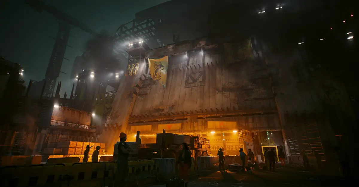 Uma personagem do jogador a olhar para a entrada fortemente fortificada para o distrito de Dogtown em Cyberpunk 2077